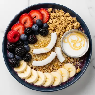"First Watch A.M. Superfoods Bowl – a chilled mix of coconut milk chia pudding, fresh bananas, berries, housemade granola, and almond butter toast, served as a nutrient-rich breakfast option.