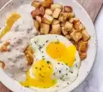 Biscuits & Turkey Sausage Gravy with Eggs from the First Watch Lunch Menu, served with creamy gravy and fluffy eggs over warm biscuits