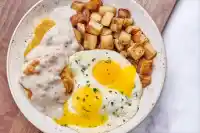 Biscuits & Turkey Sausage Gravy with Eggs from the First Watch Lunch Menu, served with creamy gravy and fluffy eggs over warm biscuits