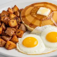 The Trifecta breakfast with a Belgian waffle or pancake, two eggs, and choice of bacon or sausage.